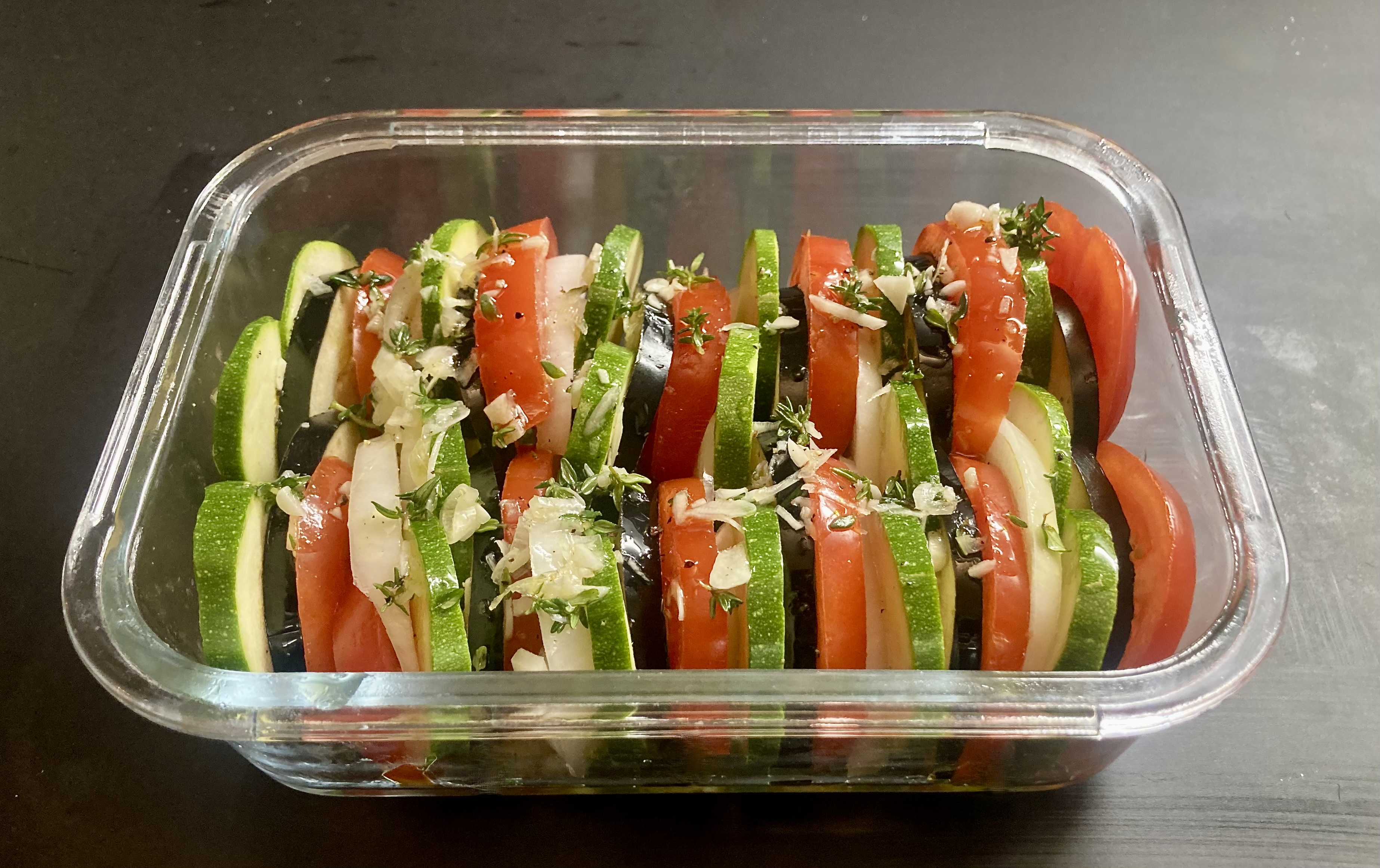 Tian - ready for the oven ©cadwu with eggplant, zuchhini, white onion and tomatoes. Also herbes de provence, garlic, olive oil and black pepper