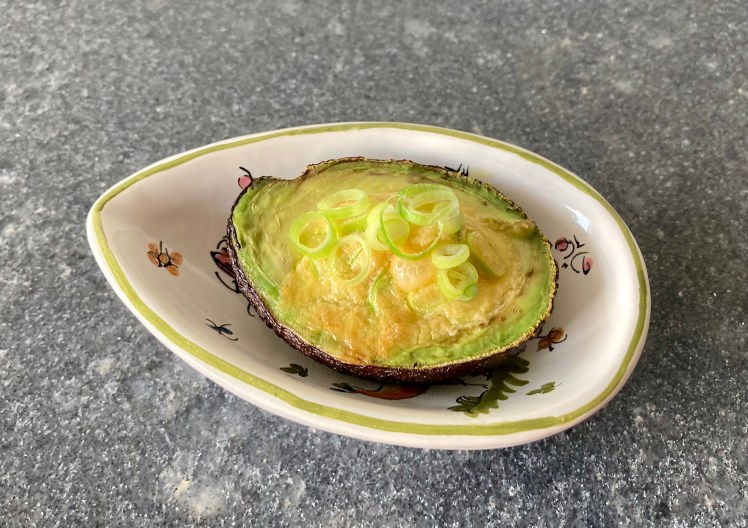 Baked Eggs in Avocado ©cadwu with crème fraîche, salt, spring onion